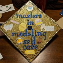 grad cap with the text "masters in modeling self-care"