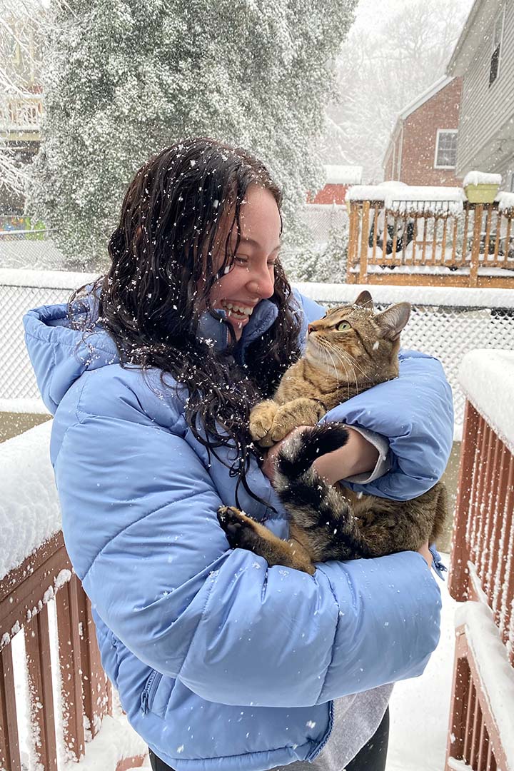 Layna Teitelbaum with her cat in the snow