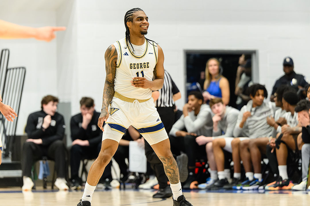 James Bishop IV standing in a uniform playing on a basketball court
