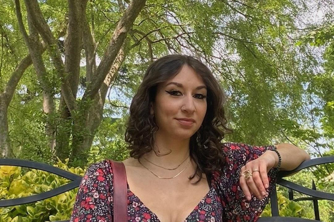 Yvonne Liccione sitting outside surrounded by trees
