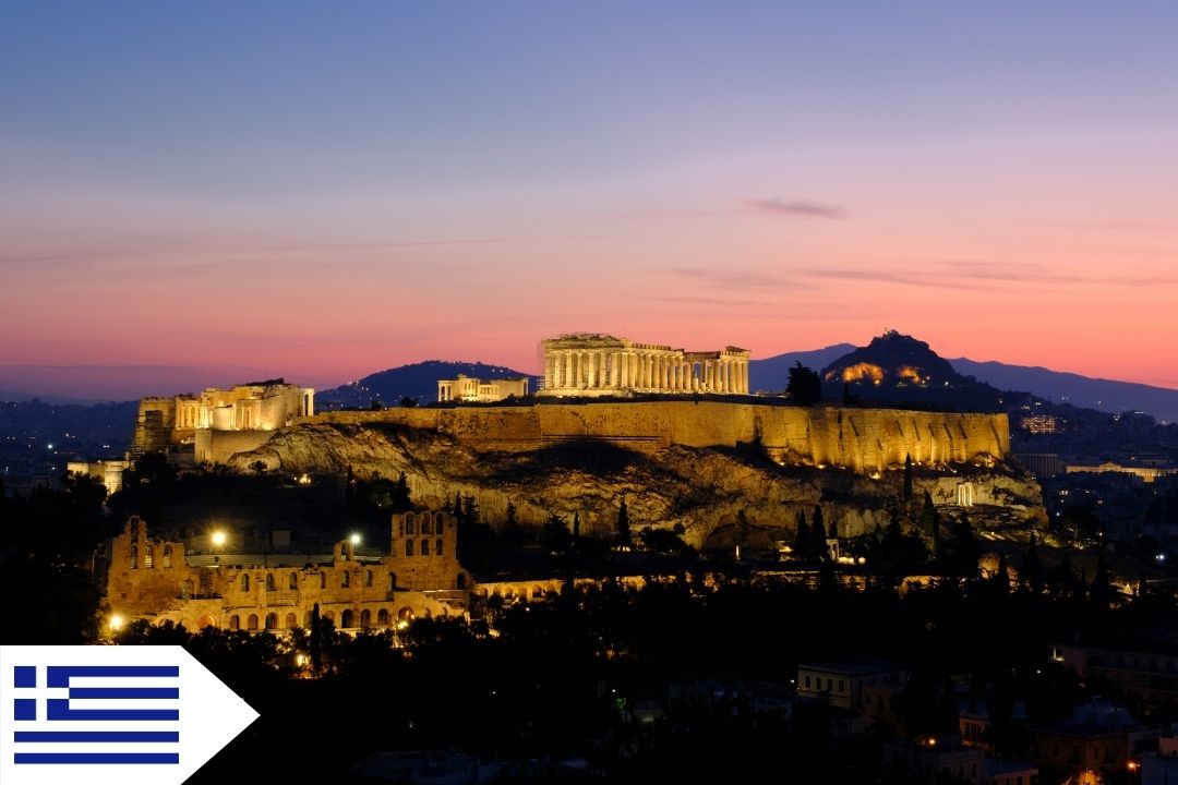 The Greek Acropolis is silhouetted against the sunrise over Athens.