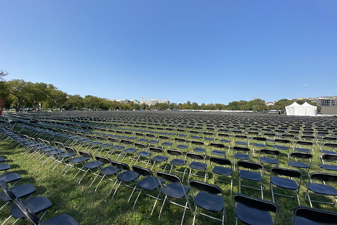 Rows of empty chairs line the grass on the National Mall