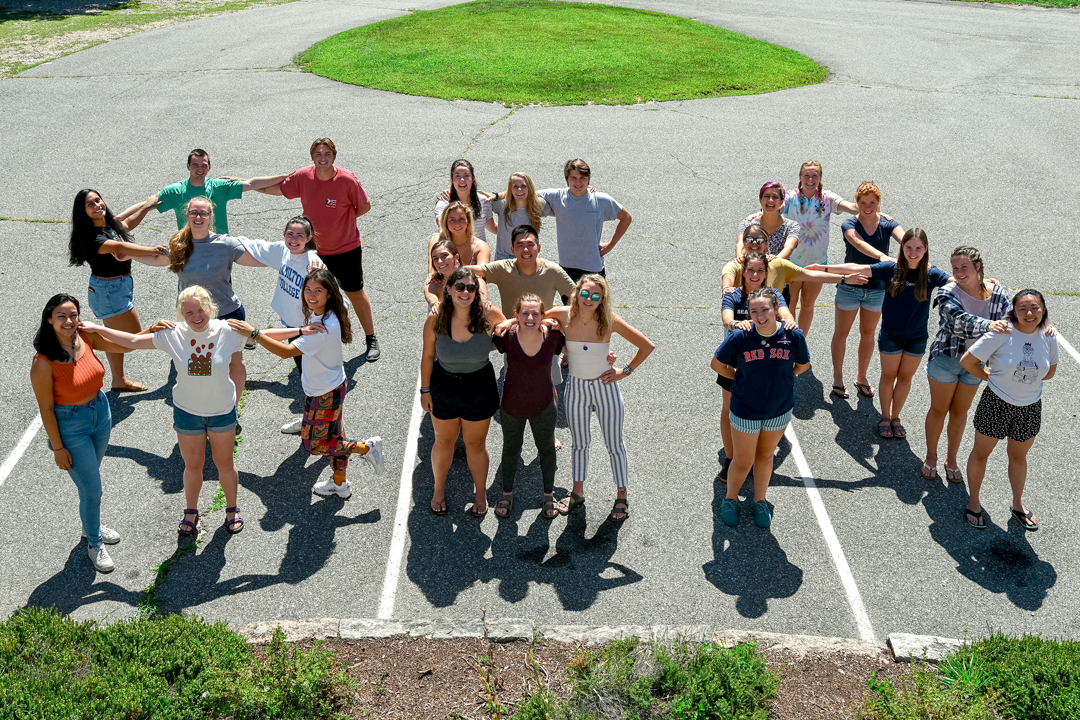 Students are standing in a parking lot spelling the word &quot;SEA&quot;