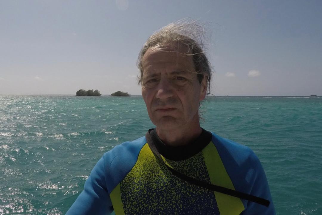 Biology professor Guillermo Orti by the ocean