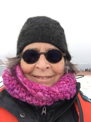 Georgeie Reynolds wearing a beanie, glasses, and scarf in Alaska