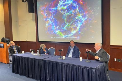 From left, CCAS Dean Paul Wahlbeck with panelists Leah Brooks, Alexander J. van der Horst and Nicholas White discussing a Webb image of a supernova remnant.