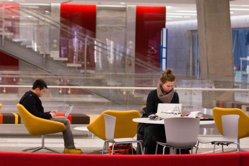 Two students studying at tables in Science and Engineering Hall