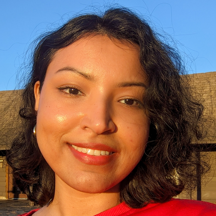 Mayeesha Azam smiling outside under a blue sky