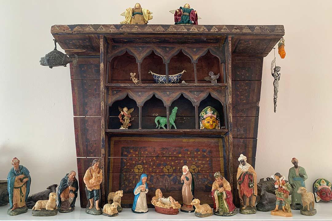A wooden nativity scene with colorful figurines
