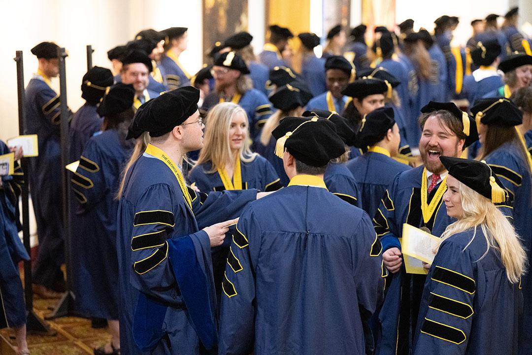 CCAS doctoral graduates and CCAS faculty in regalia