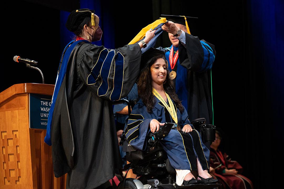 A CCAS doctoral graduate receiving her hood at the ceremony