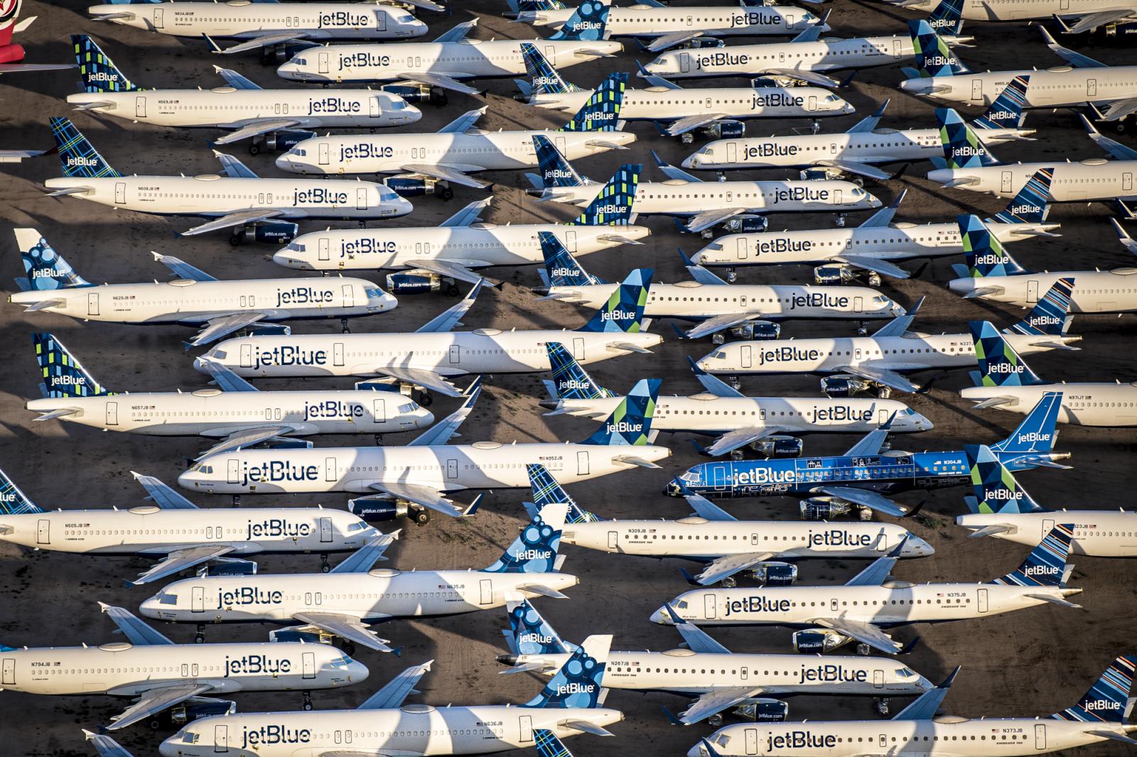 Empty JetBlue airplanes lined up in storage during COVID