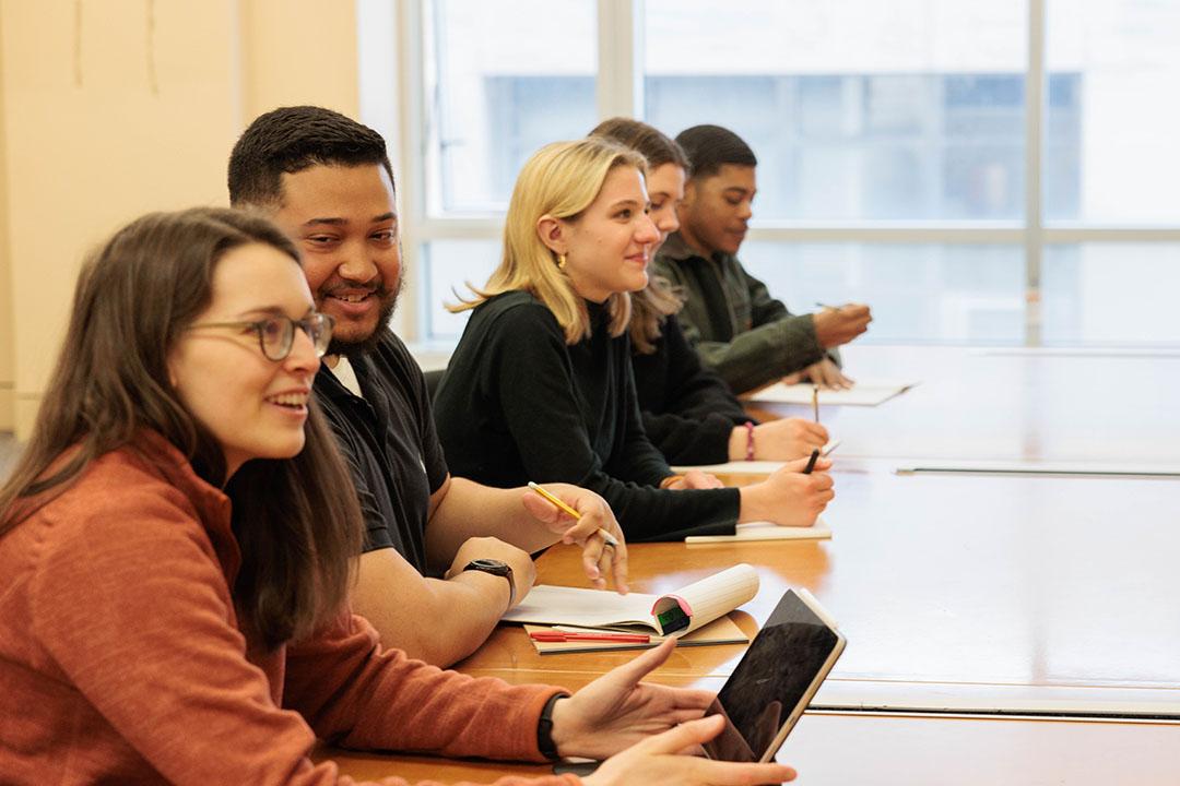 Organizational Sciences students in a row at a table