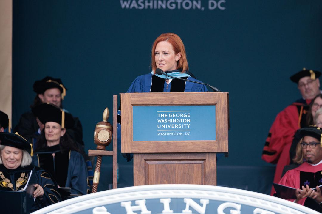 Jen Psaki delivering a speech at a podium during the 2024 GW Commencement