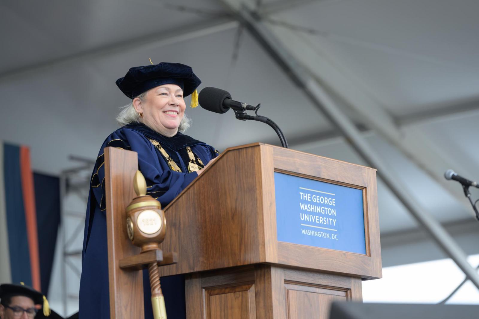 President Ellen Granberg speaking at a podium during the 2025 GW Commencement
