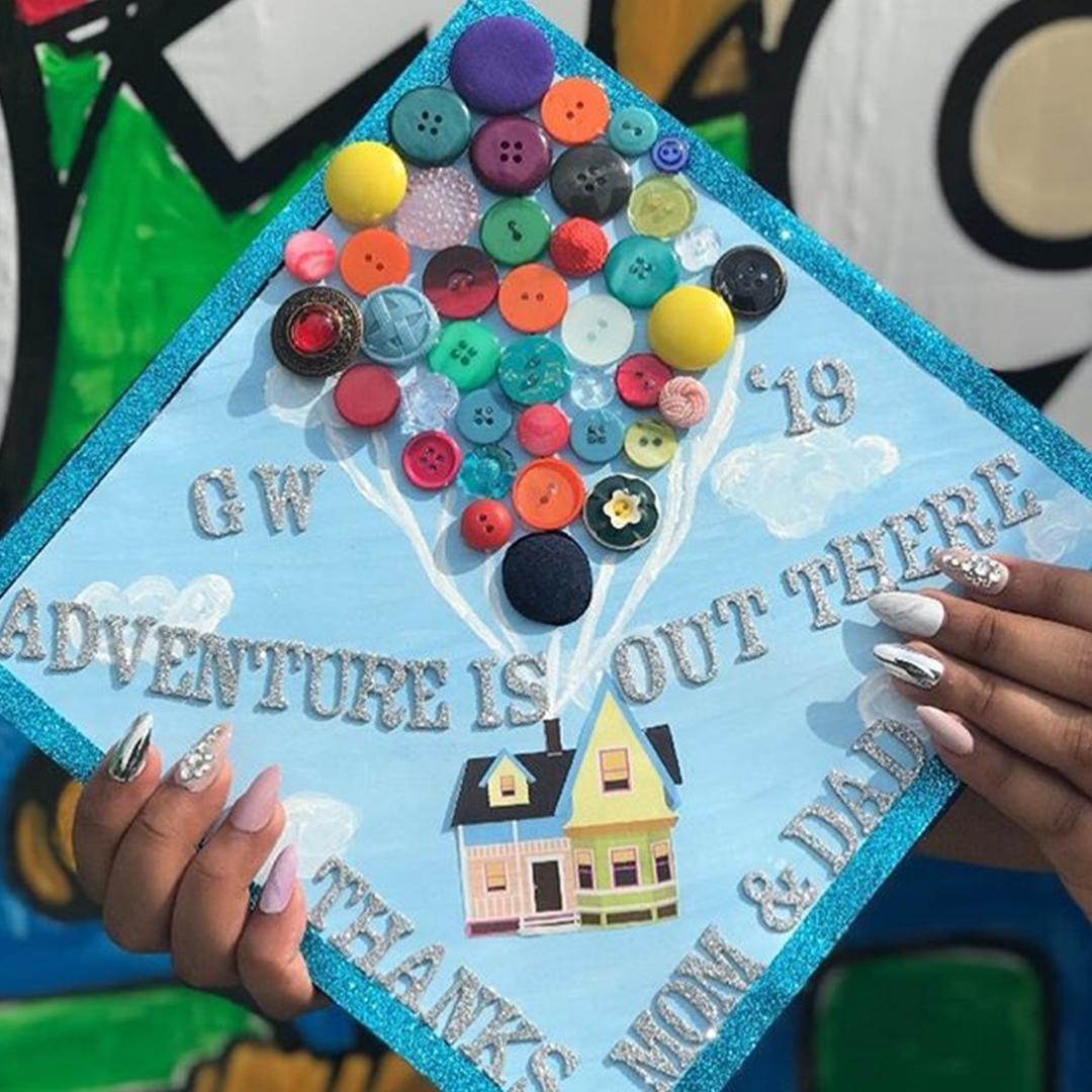 Grad cap with the text "adventure is out there thanks mom & dad"