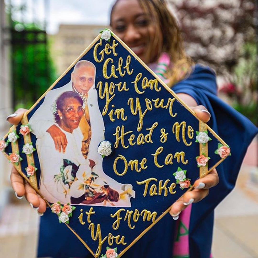 A graduation cap decorated with the text "get all you can in your head & no one can take it from you"