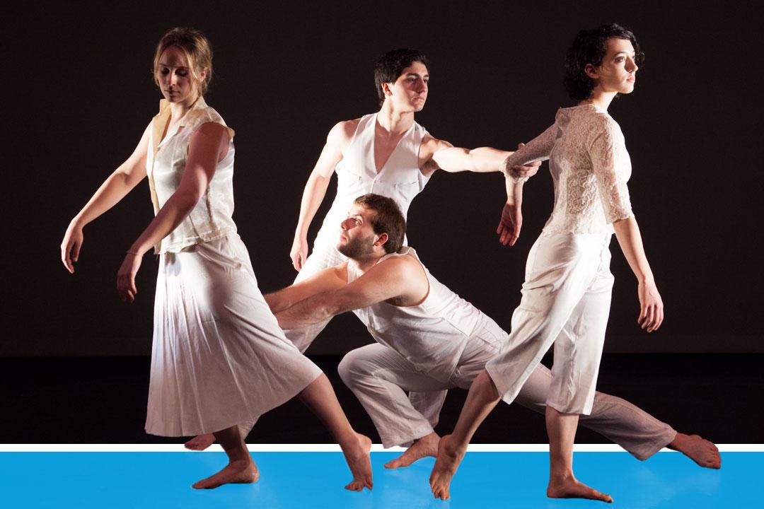 Four dancers onstage in flowing white clothes