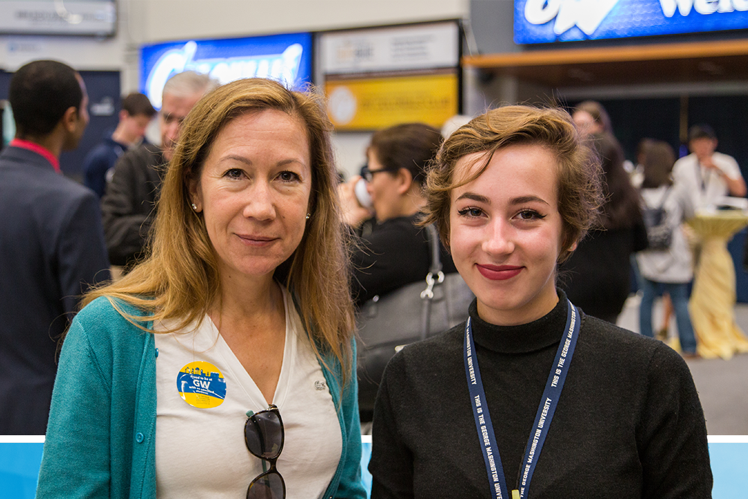 Two people, one older and one younger, smiling together at a GW event