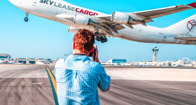 Ryan Patterson taking a photo of an airplane as it takes off