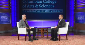 Professor David DeGrazia and CCAS Dean Paul Wahlbeck having a discussion on a stage with CCAS branding.