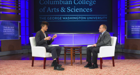 Andrew Thompson with Paul Wahlbeck talking on a stage with Columbian College Branding